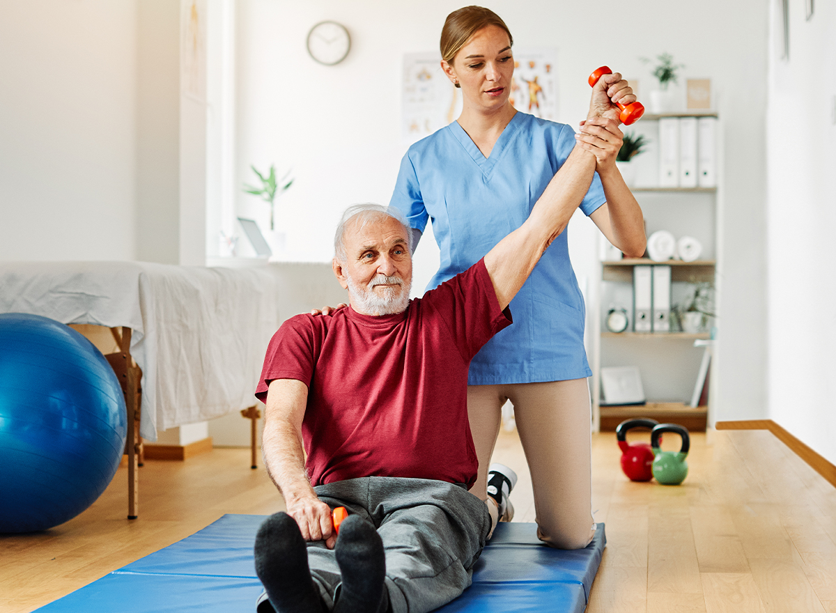 Therapist supporting a patient through balance training