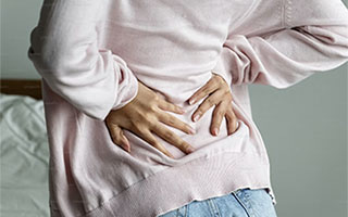 back pain Physiotherapist treating a patient at home