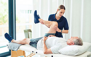 Post-Surgery Rehabilitation Physiotherapist treating a patient at home